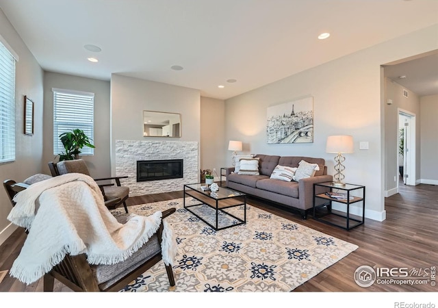 38 Morgan Cir S, Erie, CO 80516 - living room with wood finished floors, a glass covered fireplace, baseboards, and recessed lighting