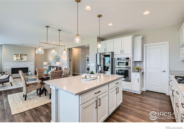 38 Morgan Cir S, Erie, CO 80516 - kitchen featuring stainless steel appliances, dark wood-type flooring, light countertops, and recessed lighting