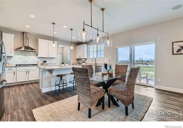 38 Morgan Cir S, Erie, CO 80516 - dining space featuring dark wood-style flooring, recessed lighting, and baseboards