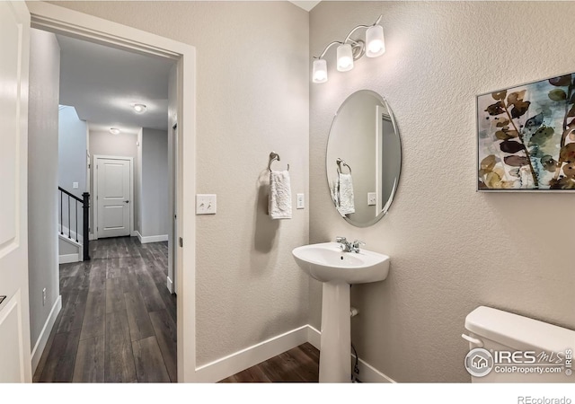 38 Morgan Cir S, Erie, CO 80516 - half bath with wood finished floors, baseboards, toilet, and a sink