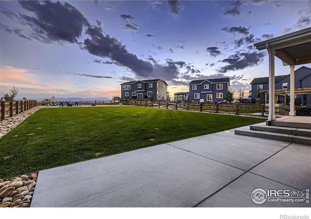 38 Morgan Cir S, Erie, CO 80516 - yard at dusk with a patio area and a residential view