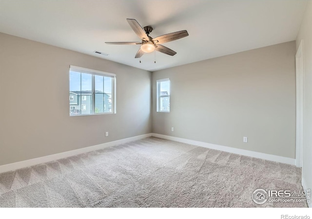 38 Morgan Cir S, Erie, CO 80516 - spare room featuring a ceiling fan, baseboards, and light colored carpet
