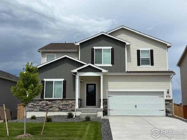 974 Cascade Falls St, Severance, CO 80550 - view of front of property with stone siding, board and batten siding, and an attached garage
