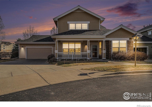 4751 Pleasant Oak Dr Unit C65, Fort Collins, CO 80525 - view of front facade with driveway, covered porch, a garage, and a shingled roof