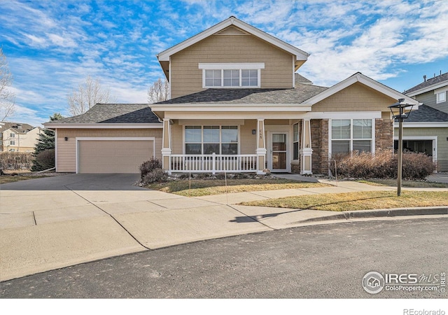 4751 Pleasant Oak Dr Unit C65, Fort Collins, CO 80525 - view of front facade with driveway, a shingled roof, an attached garage, and a porch