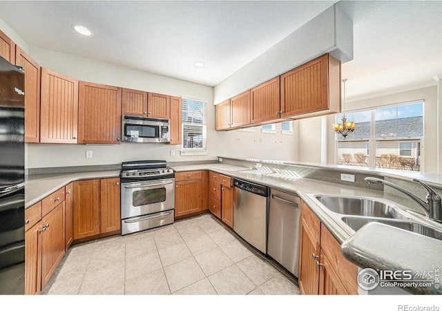 4751 Pleasant Oak Dr Unit C65, Fort Collins, CO 80525 - kitchen with recessed lighting, appliances with stainless steel finishes, a sink, an inviting chandelier, and light tile patterned floors