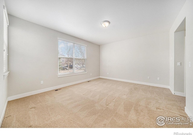 4751 Pleasant Oak Dr Unit C65, Fort Collins, CO 80525 - spare room featuring baseboards, light colored carpet, and visible vents