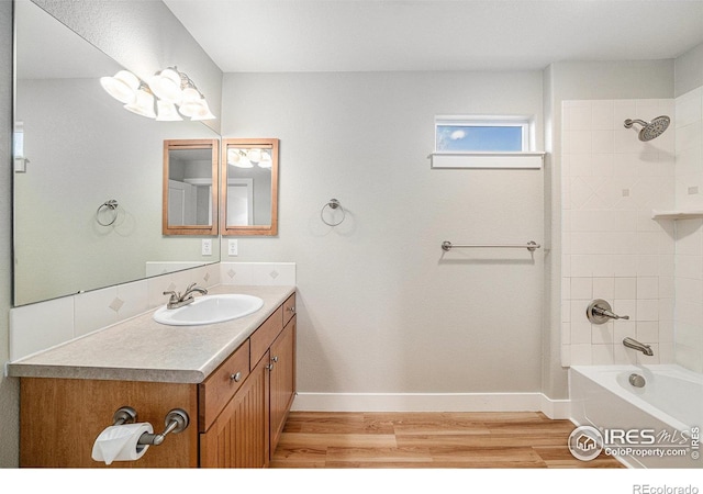 4751 Pleasant Oak Dr Unit C65, Fort Collins, CO 80525 - full bathroom with baseboards, wood finished floors, vanity, and shower / bathtub combination
