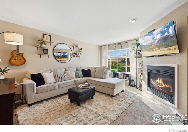 living room with a glass covered fireplace