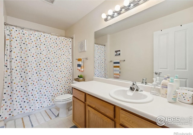full bathroom featuring a shower with curtain, toilet, vanity, and tile patterned flooring