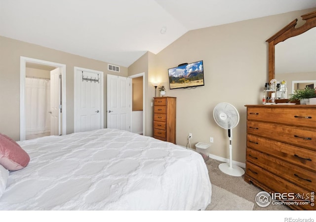 carpeted bedroom featuring baseboards, visible vents, and vaulted ceiling