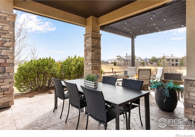 view of patio featuring a pergola and outdoor dining space