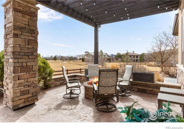 view of patio featuring a fire pit and a pergola