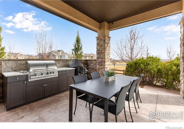 view of patio with a grill, outdoor dining space, and area for grilling