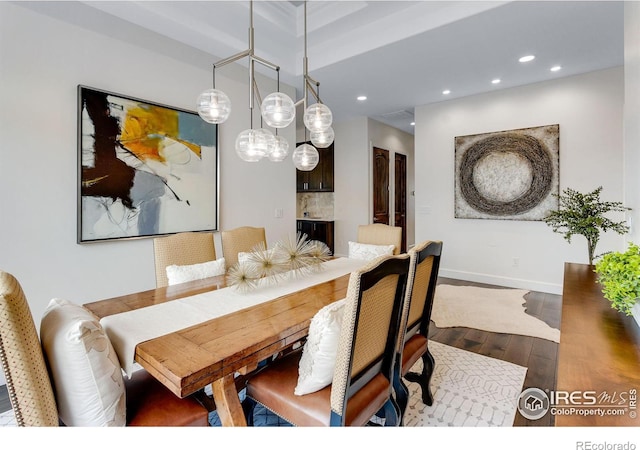 dining room featuring baseboards, wood finished floors, and recessed lighting