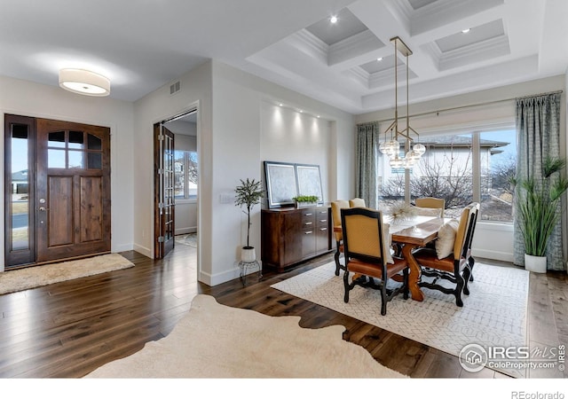 dining room with a wealth of natural light, coffered ceiling, hardwood / wood-style flooring, and visible vents