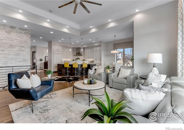 living area featuring light wood-style flooring, recessed lighting, and a ceiling fan