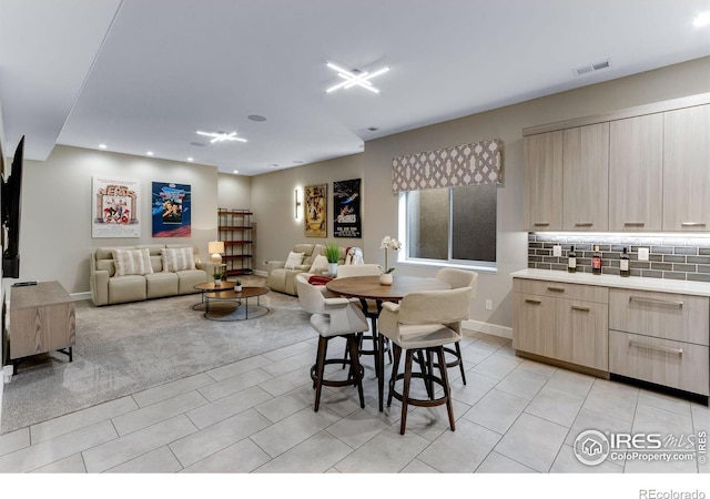 dining space featuring light tile patterned flooring, baseboards, light colored carpet, visible vents, and recessed lighting