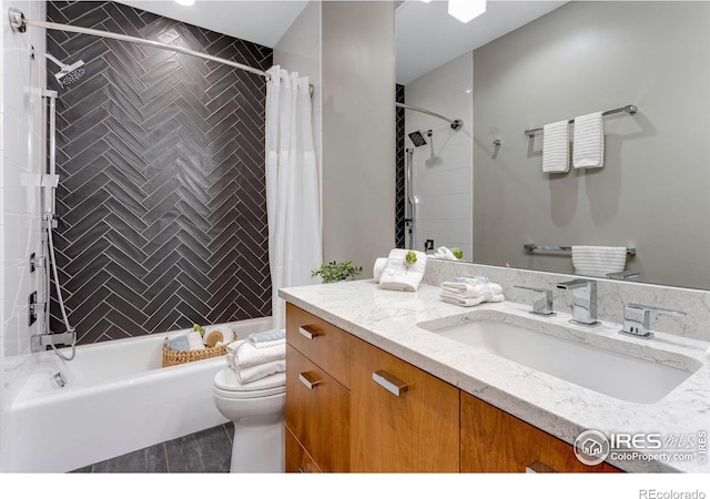 bathroom with toilet, shower / bath combo with shower curtain, and vanity