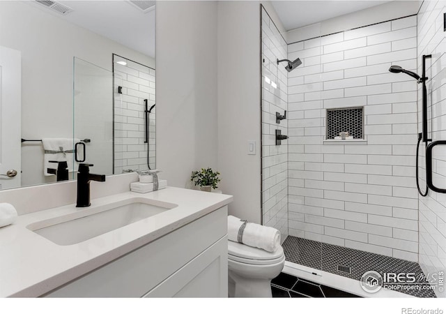 full bath with a stall shower, visible vents, toilet, and vanity