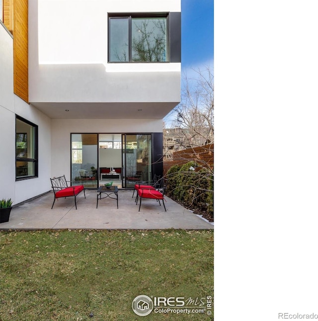 2304 Pearl St Unit 2, Boulder, CO 80302 - back of house with stucco siding, a patio, and a lawn