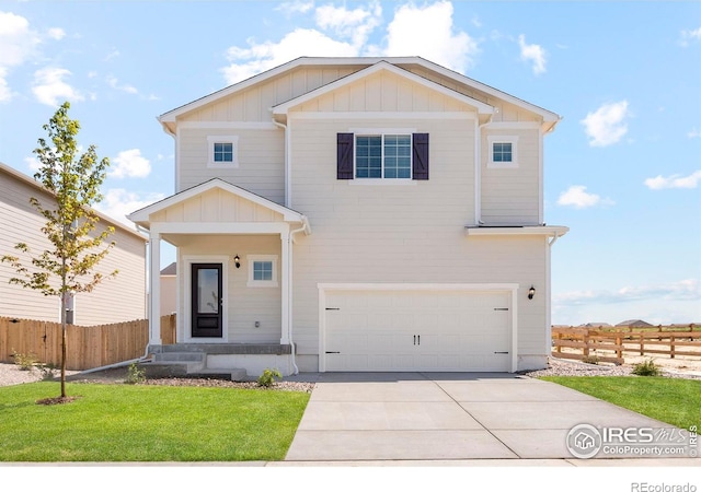 view of front facade featuring concrete driveway, fence, board and batten siding, a front yard, and a garage