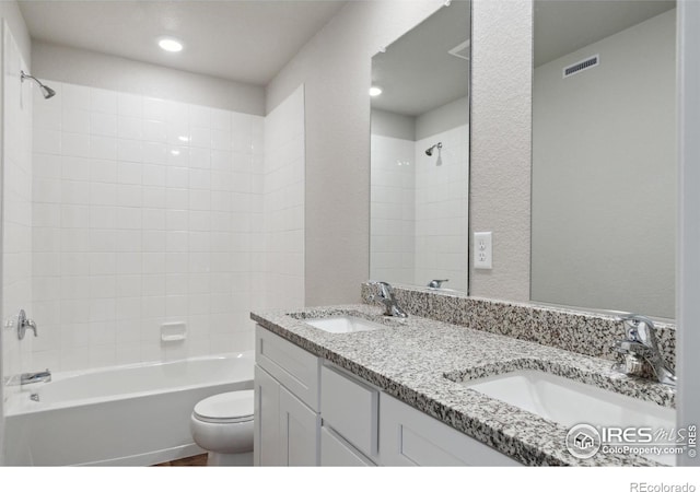 bathroom with visible vents, a sink, toilet, and shower / bathtub combination