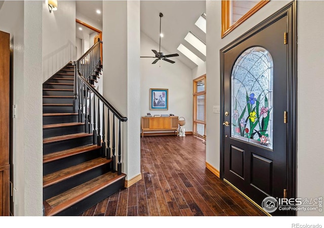 entrance foyer featuring a high ceiling, a ceiling fan, stairway, and dark wood finished floors