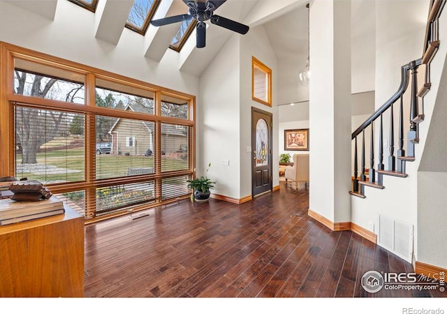 entrance foyer featuring high vaulted ceiling, a ceiling fan, wood finished floors, baseboards, and visible vents