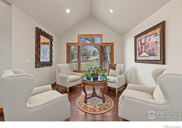 living room with dark wood-type flooring, lofted ceiling, baseboards, and recessed lighting