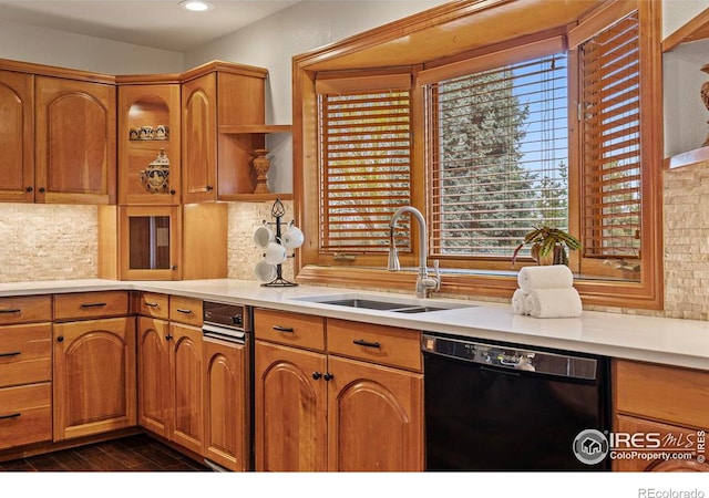 kitchen featuring light countertops, a sink, open shelves, black dishwasher, and decorative backsplash