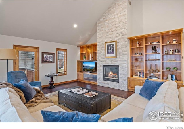 living area with high vaulted ceiling, a fireplace, wood finished floors, baseboards, and visible vents