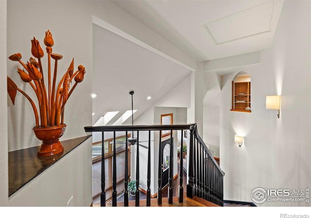stairs featuring vaulted ceiling with beams and wood finished floors