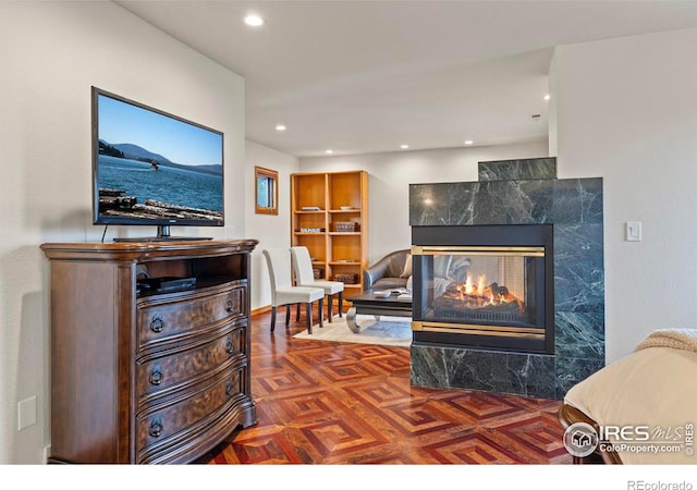 living area featuring a high end fireplace and recessed lighting