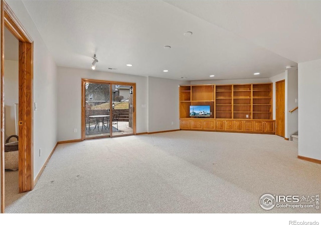unfurnished living room with carpet flooring, baseboards, stairway, and recessed lighting