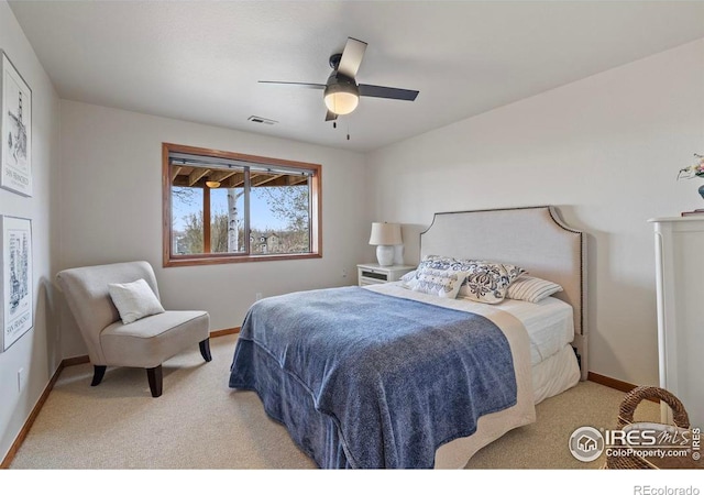 bedroom with baseboards, ceiling fan, visible vents, and light carpet