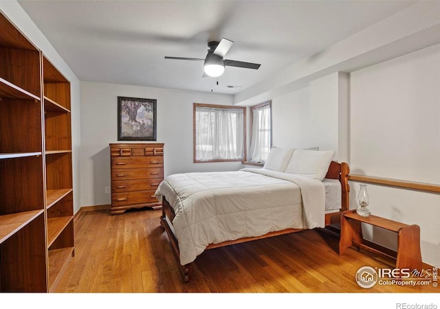 bedroom featuring a ceiling fan and wood finished floors