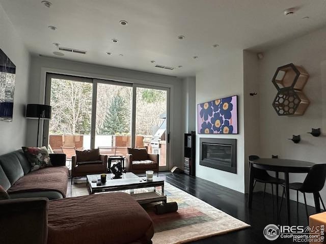 100 E Cooper Ave E Unit 7, Aspen, CO 81611 - living area featuring a glass covered fireplace, wood finished floors, visible vents, and recessed lighting