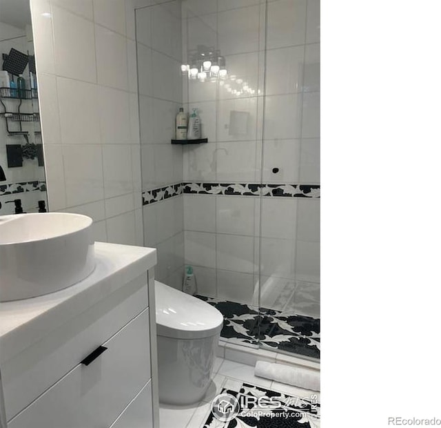 100 E Cooper Ave E Unit 7, Aspen, CO 81611 - bathroom featuring toilet, tile walls, a stall shower, marble finish floor, and vanity