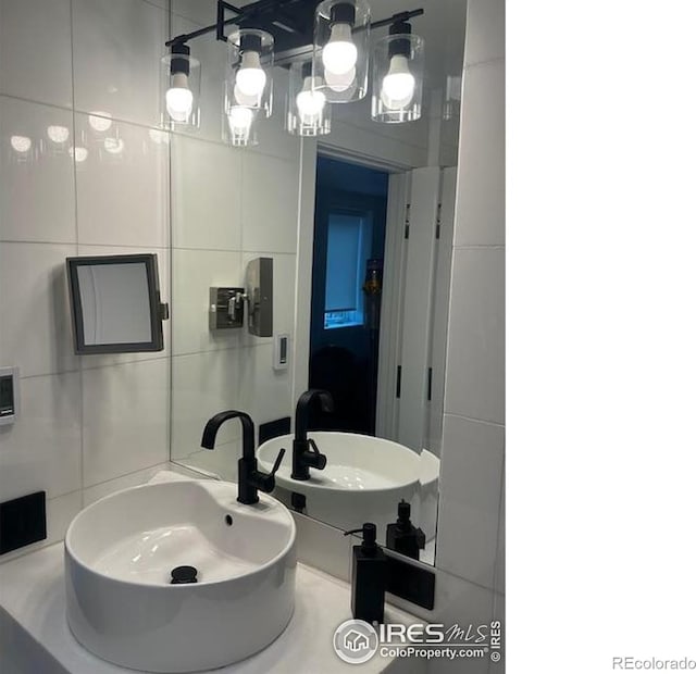 100 E Cooper Ave E Unit 7, Aspen, CO 81611 - bathroom featuring a sink and tile walls