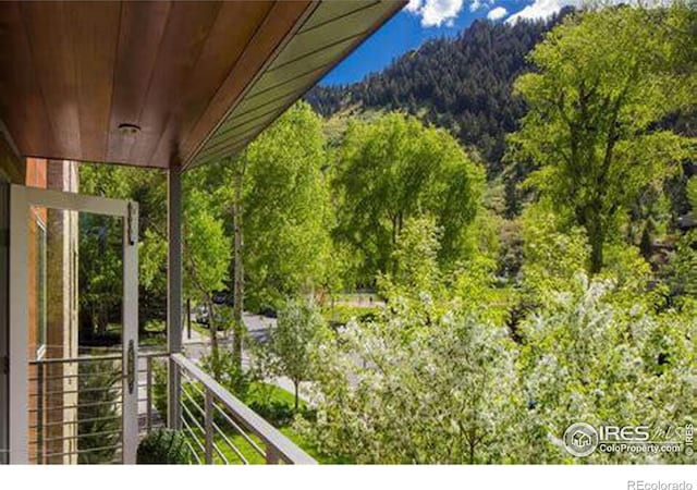100 E Cooper Ave E Unit 7, Aspen, CO 81611 - balcony featuring a wooded view