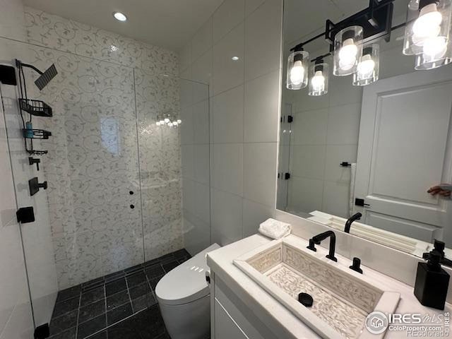 100 E Cooper Ave E Unit 7, Aspen, CO 81611 - bathroom with toilet, tile walls, a tile shower, recessed lighting, and vanity