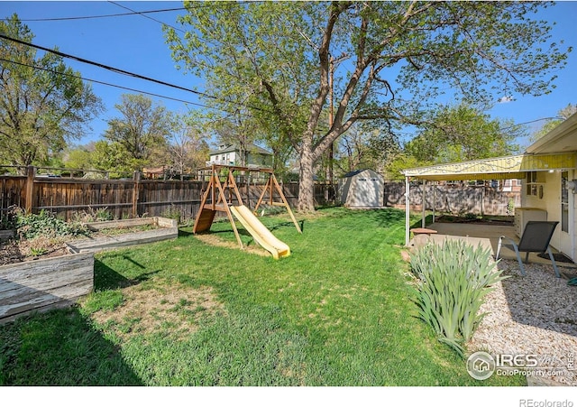 2 Lincoln Pl, Longmont, CO 80501 - view of yard featuring a shed, a playground, an outbuilding, and a vegetable garden