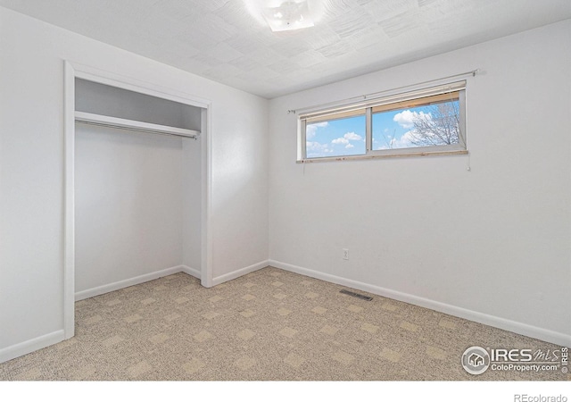 2 Lincoln Pl, Longmont, CO 80501 - unfurnished bedroom with carpet floors, baseboards, and a closet