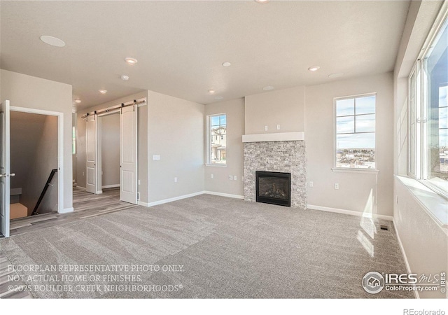 2387 Bristol St, Superior, CO 80027 - unfurnished living room with a barn door, plenty of natural light, baseboards, recessed lighting, and a fireplace