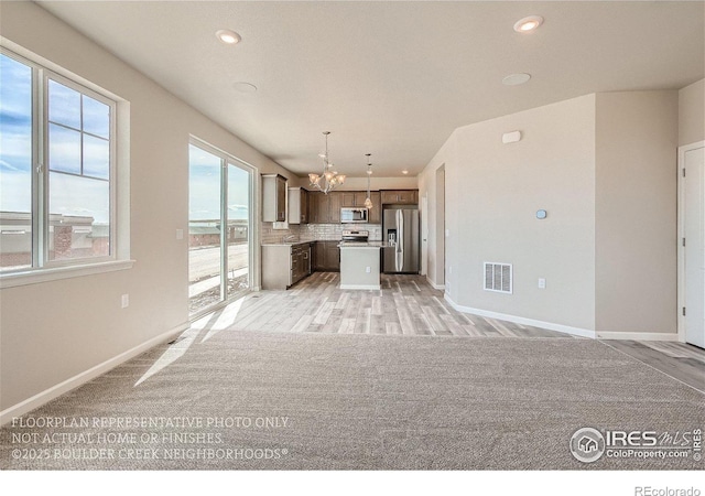 2387 Bristol St, Superior, CO 80027 - unfurnished living room featuring a chandelier, baseboards, recessed lighting, and light wood-style flooring