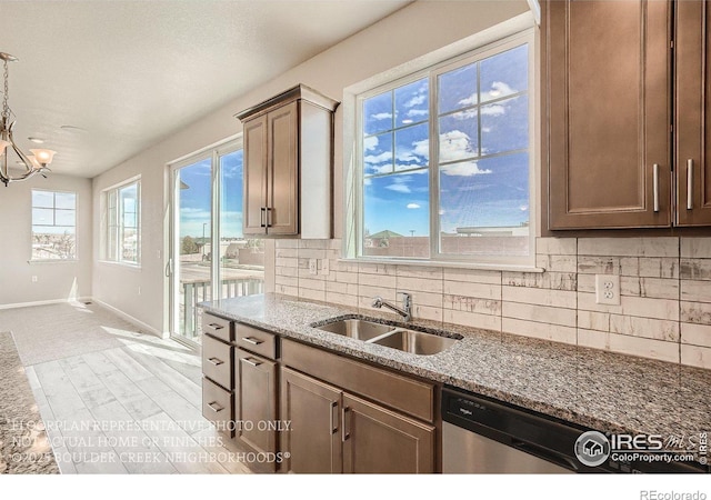 2387 Bristol St, Superior, CO 80027 - kitchen featuring a sink, tasteful backsplash, stone countertops, and baseboards
