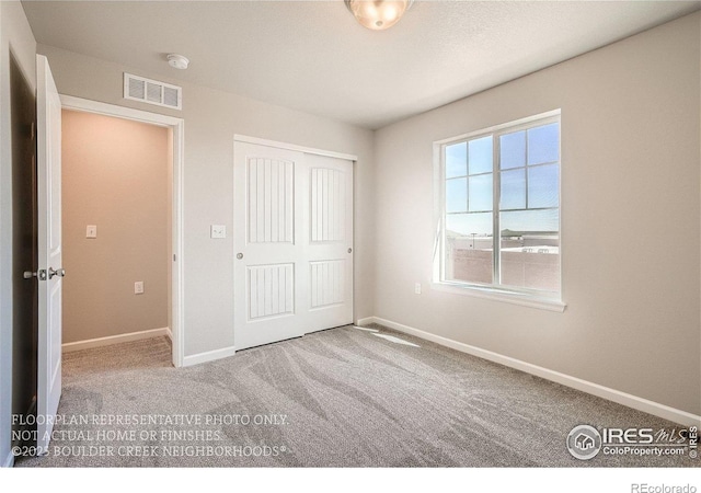 2387 Bristol St, Superior, CO 80027 - unfurnished bedroom with carpet flooring, baseboards, and a closet