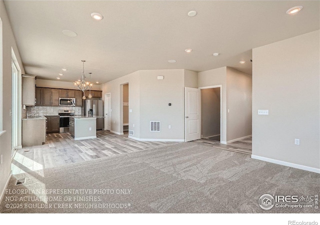 2387 Bristol St, Superior, CO 80027 - unfurnished living room featuring a chandelier, recessed lighting, and baseboards