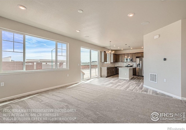 2387 Bristol St, Superior, CO 80027 - unfurnished living room featuring a chandelier, baseboards, recessed lighting, and light carpet